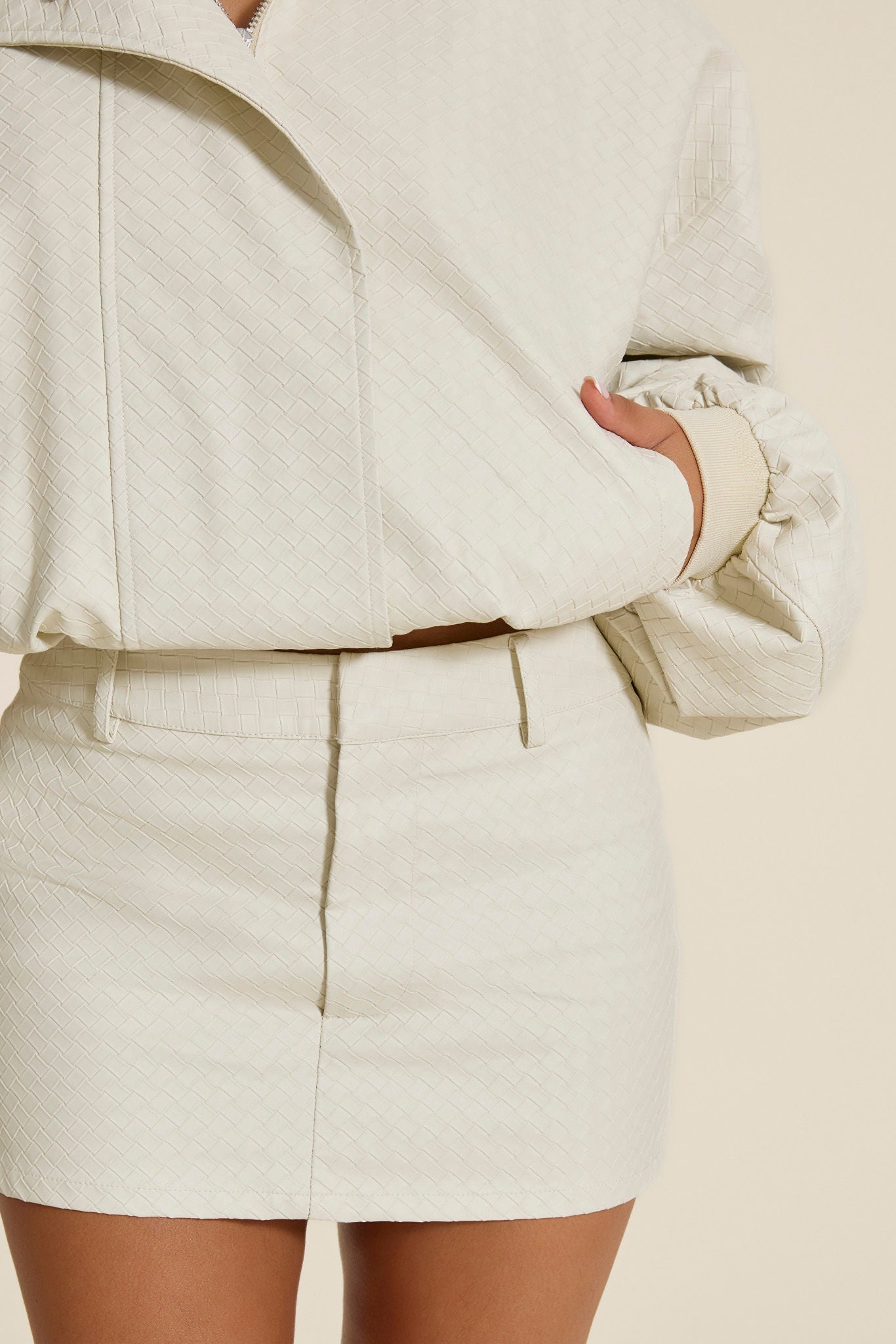 The Nyra Faux Leather Mini Skirt in Off White